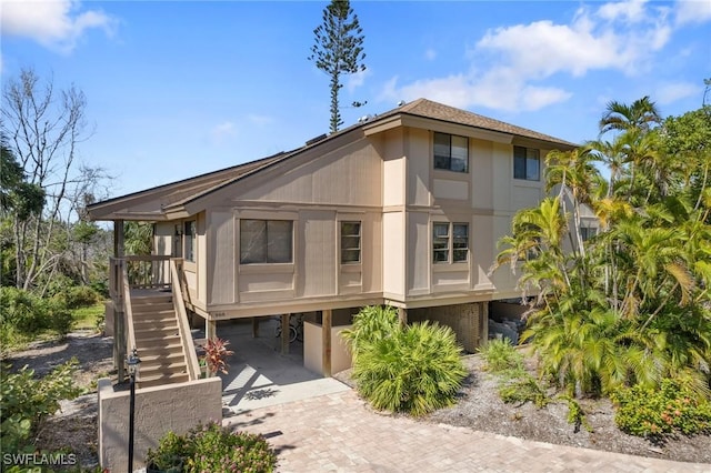 rear view of property with a carport