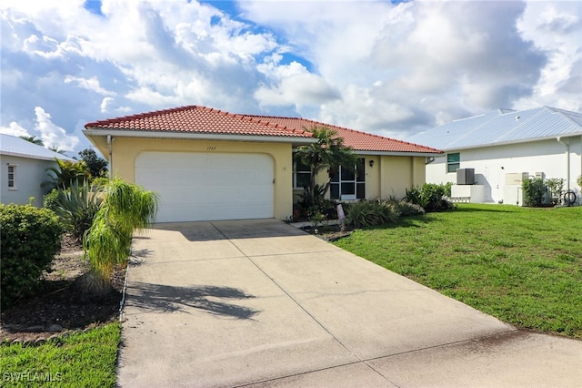 view of front of home with a front lawn and a garage