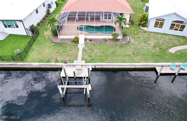 rear view of property with a water view, glass enclosure, and a lawn