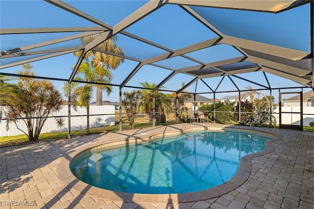 view of pool featuring a patio and glass enclosure