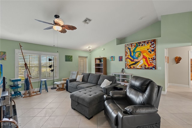 living room featuring ceiling fan, lofted ceiling, and light tile patterned flooring