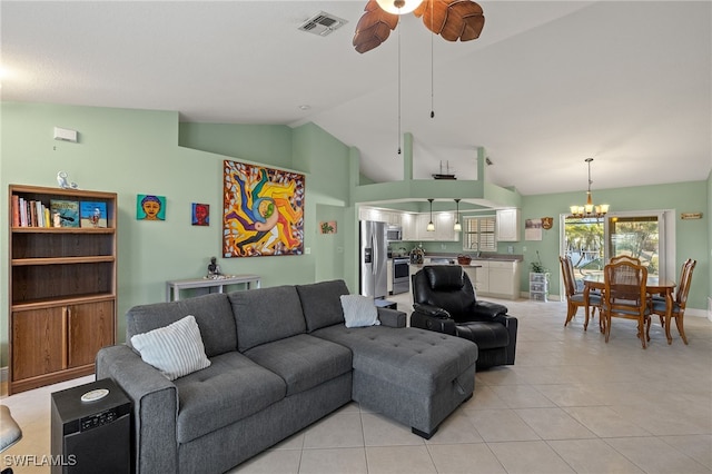 tiled living room with ceiling fan with notable chandelier and vaulted ceiling