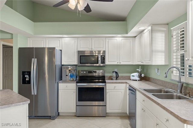 kitchen with white cabinetry, sink, light tile patterned floors, and appliances with stainless steel finishes