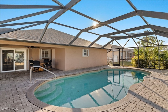 view of pool with ceiling fan, a lanai, and a patio