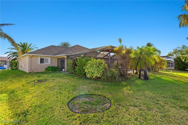 ranch-style house featuring a front lawn and a lanai