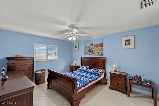 tiled bedroom with ceiling fan