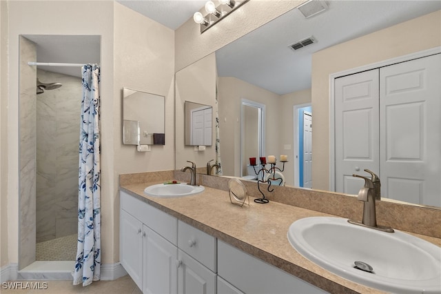 bathroom featuring vanity, tile patterned floors, and curtained shower