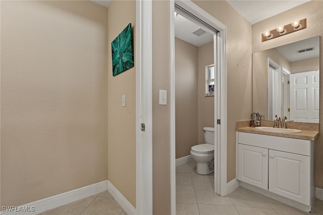 bathroom with tile patterned floors, vanity, and toilet