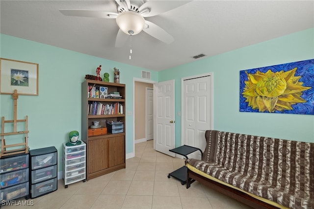 sitting room featuring light tile patterned floors and ceiling fan