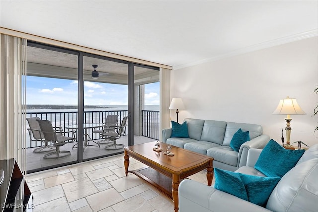 living room featuring crown molding, expansive windows, and a water view