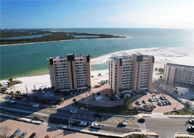 birds eye view of property featuring a beach view and a water view