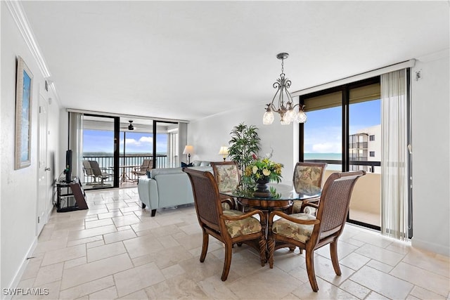 dining space featuring ornamental molding, a healthy amount of sunlight, and a water view