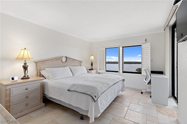 bedroom featuring crown molding and a water view