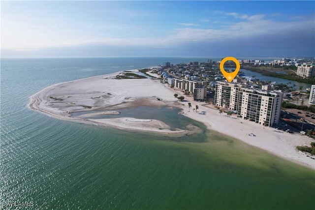 birds eye view of property with a water view and a view of the beach