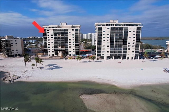 view of property with a water view and a view of the beach