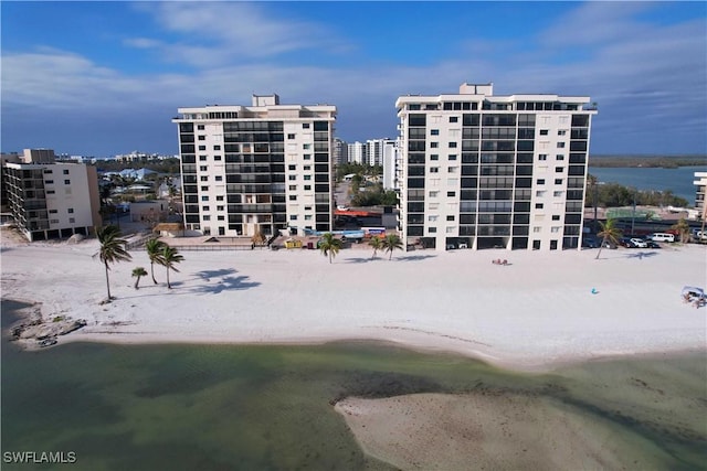 view of property featuring a beach view and a water view