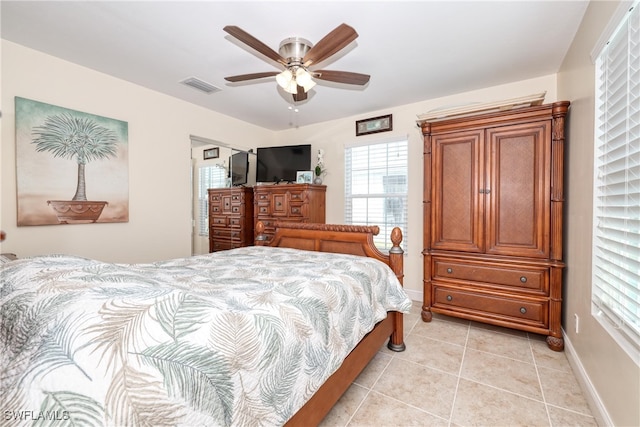 tiled bedroom featuring ceiling fan