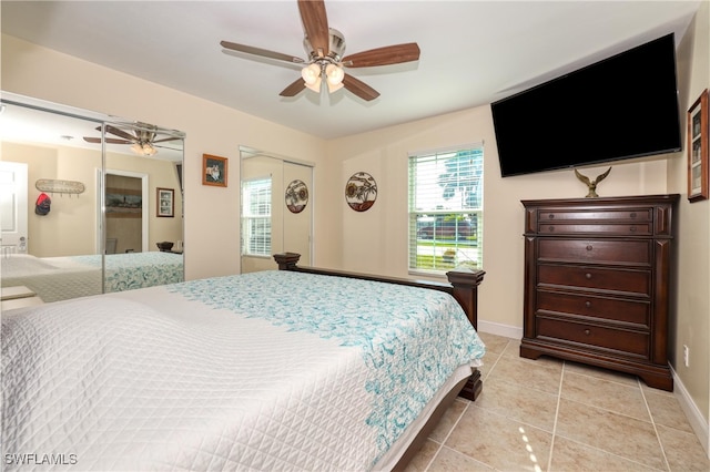 bedroom with ceiling fan and light tile patterned flooring