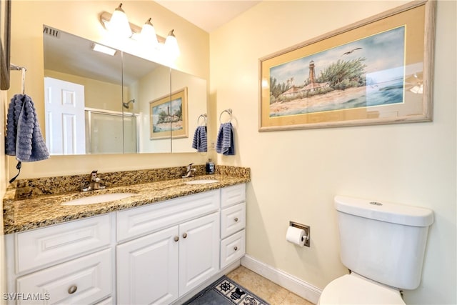 bathroom featuring vanity, toilet, tile patterned flooring, and walk in shower