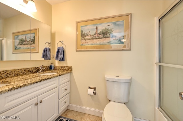 bathroom featuring tile patterned flooring, vanity, toilet, and a shower with door