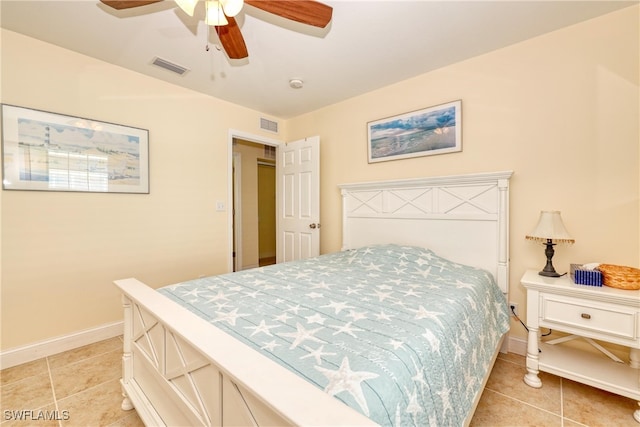 tiled bedroom featuring ceiling fan