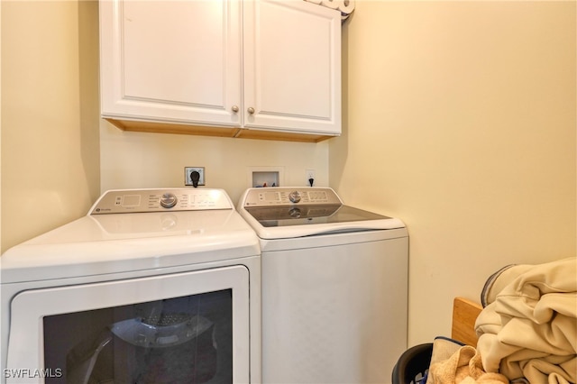 washroom with cabinets and separate washer and dryer