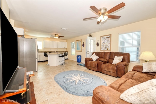 living room with light tile patterned floors and ceiling fan