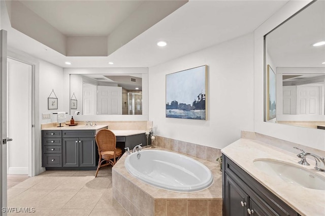 bathroom with tile patterned floors, vanity, and separate shower and tub