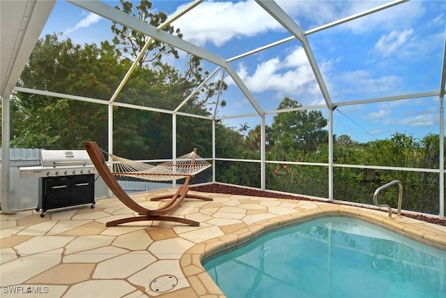 view of pool featuring glass enclosure and a patio area