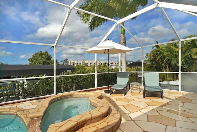 view of patio / terrace featuring a lanai and a hot tub