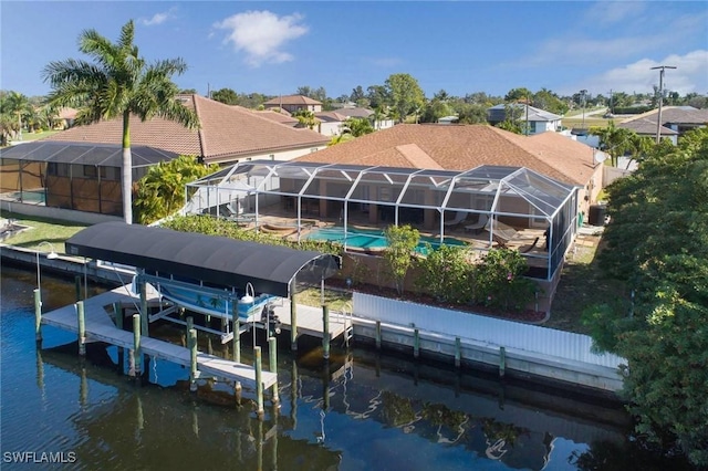 view of dock with a lanai and a water view