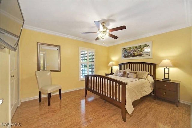 bedroom featuring hardwood / wood-style flooring, ceiling fan, and ornamental molding