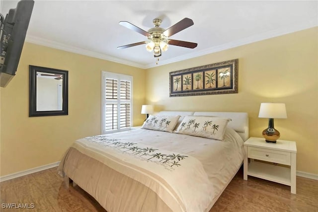 bedroom featuring hardwood / wood-style flooring, ceiling fan, and crown molding