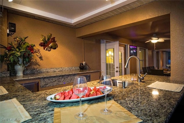 kitchen with beam ceiling, ceiling fan, and sink