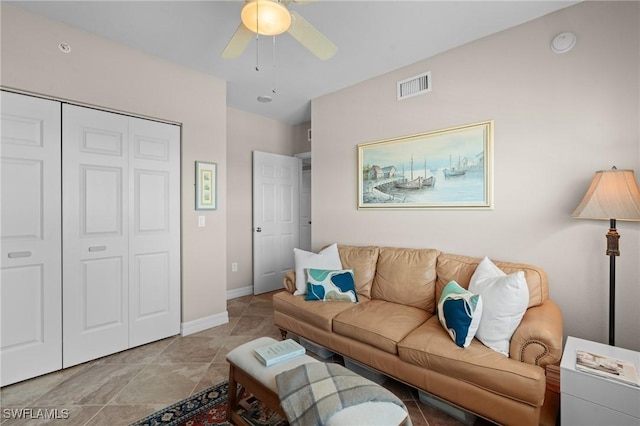 living room with light tile patterned flooring and ceiling fan