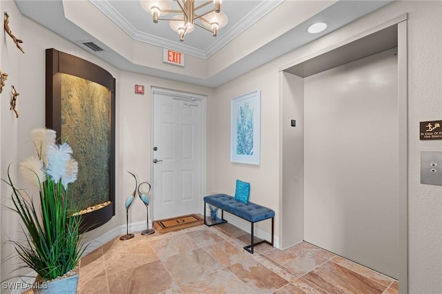 entrance foyer featuring a raised ceiling, an inviting chandelier, crown molding, and elevator