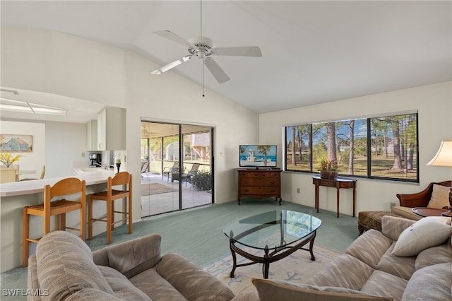 living room with ceiling fan, vaulted ceiling, and light carpet