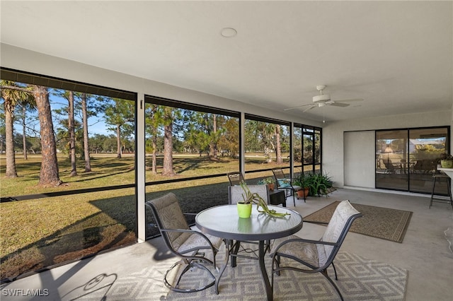 sunroom / solarium featuring a wealth of natural light and ceiling fan