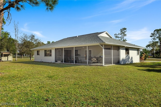 back of property with a sunroom and a lawn