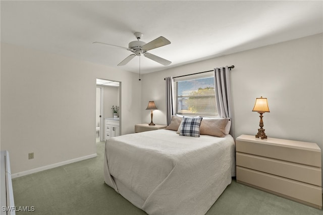 carpeted bedroom with connected bathroom and ceiling fan