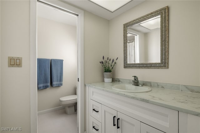 bathroom featuring vanity, tile patterned floors, and toilet