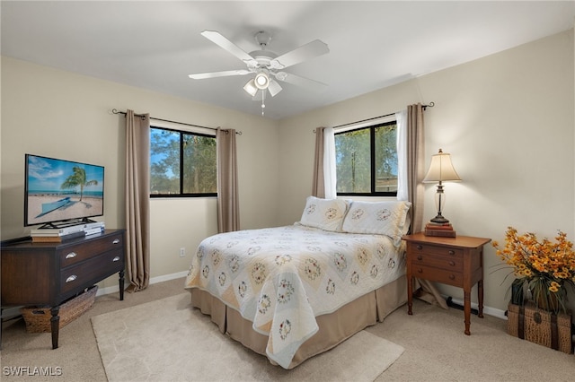 bedroom with light carpet and ceiling fan