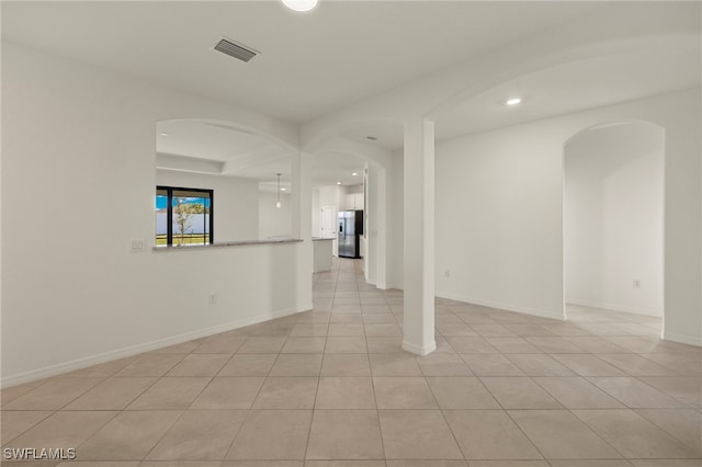 spare room featuring light tile patterned flooring