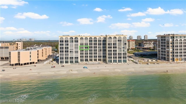 drone / aerial view with a water view and a view of the beach