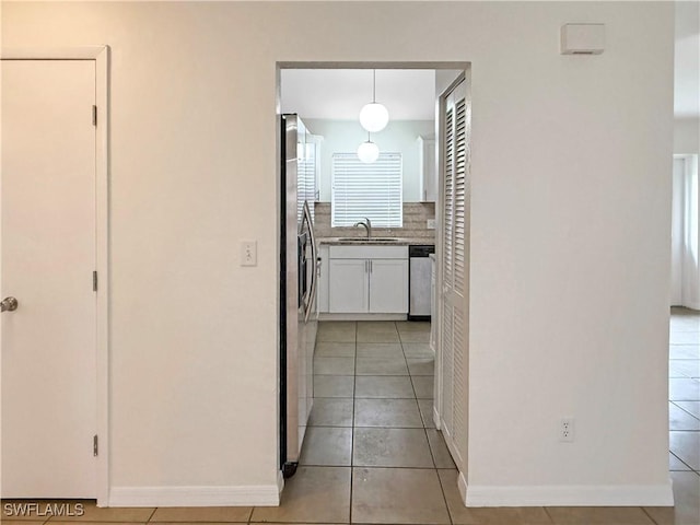 hallway with sink and light tile patterned floors