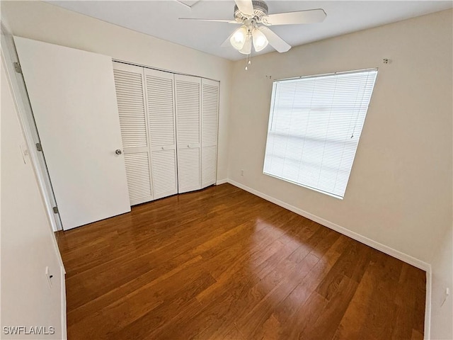 unfurnished bedroom with a closet, ceiling fan, and hardwood / wood-style flooring