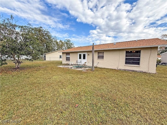 rear view of house with a patio area and a yard