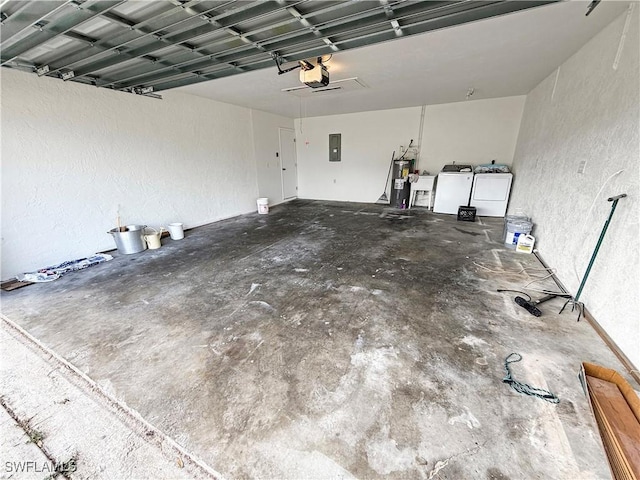 garage featuring a garage door opener, independent washer and dryer, and electric panel