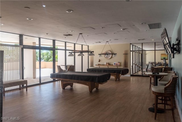 rec room with floor to ceiling windows, hardwood / wood-style flooring, and pool table