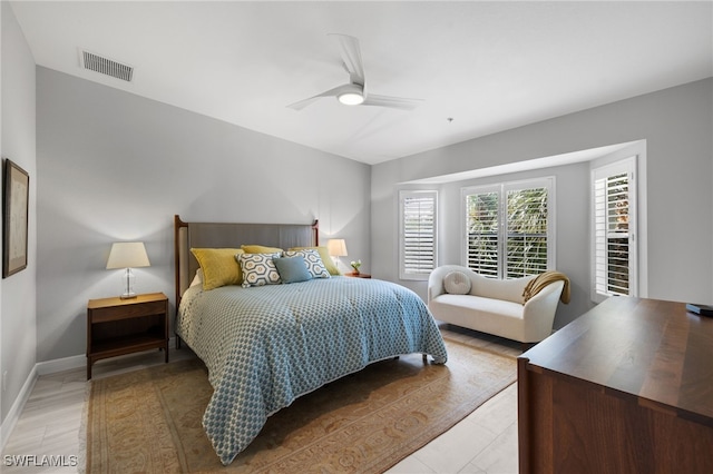 bedroom with ceiling fan, visible vents, and baseboards